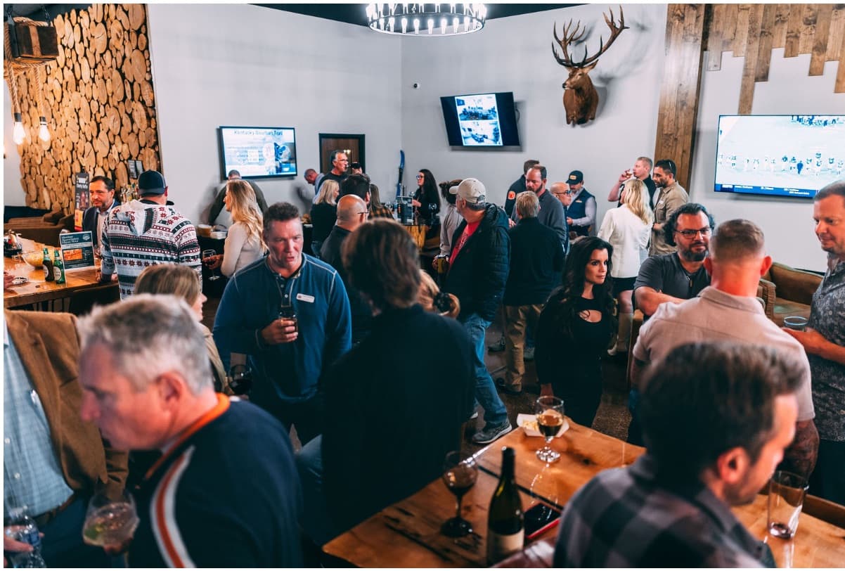 Members mingling during a packed clubhouse event